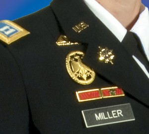 How to inspect an army uniform for proper placement of insignia, badges, and nameplates