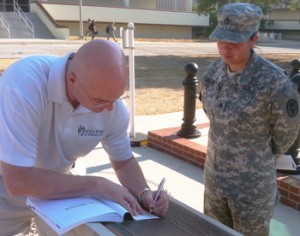 Mark Gerecht signs a copy of The Mentor for a Soldier on Fort Sam Houston